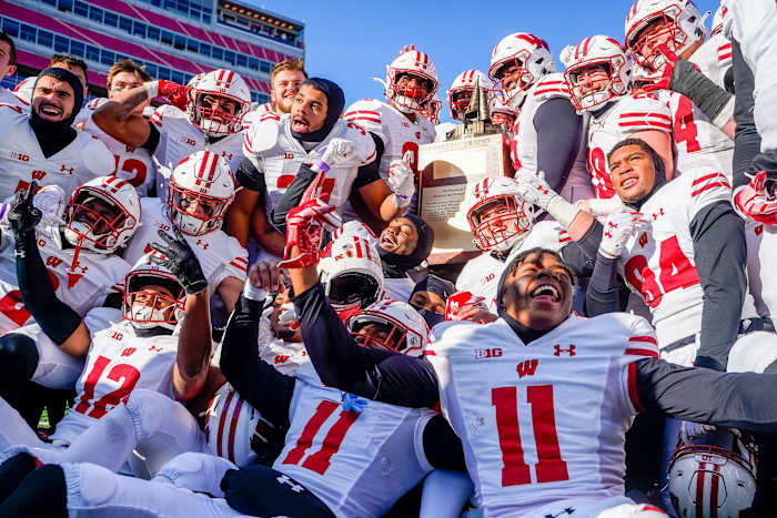 Nov 19, 2022; Lincoln, Nebraska, USA; The Wisconsin Badgers hoist the Freedom Trophy after defeating the Nebraska Cornhuskers 15-14 at Memorial Stadium. Mandatory Credit: Dylan Widger-USA TODAY Sports